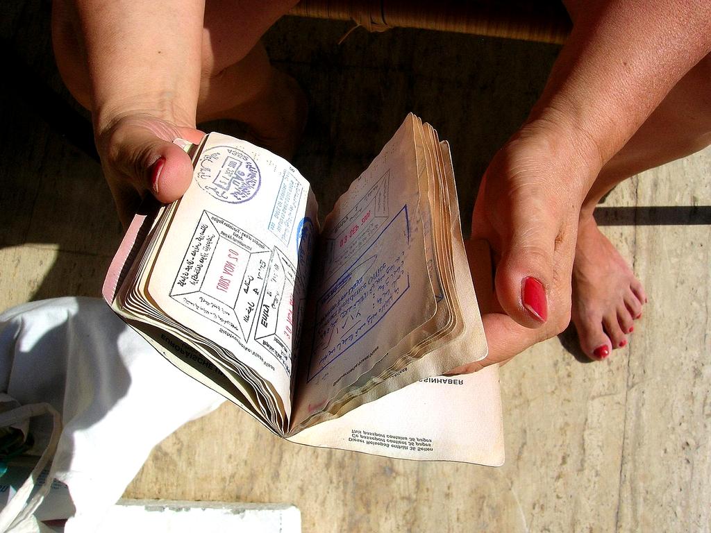 Traveler talking on phone with travel documents on table